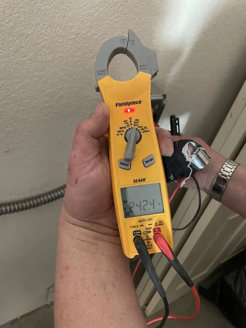 Voltage testing with clamp meter during Outlet Installation in Mendota Heights